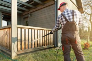 Man power washing a deck in a backyard in Kings Beach, California
