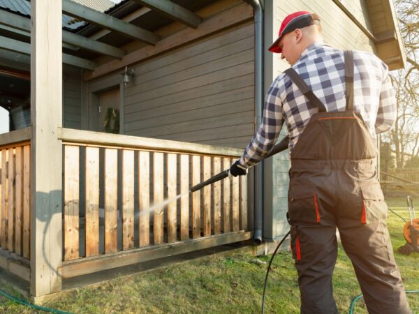 Man power washing a deck in a backyard in Kings Beach, California
